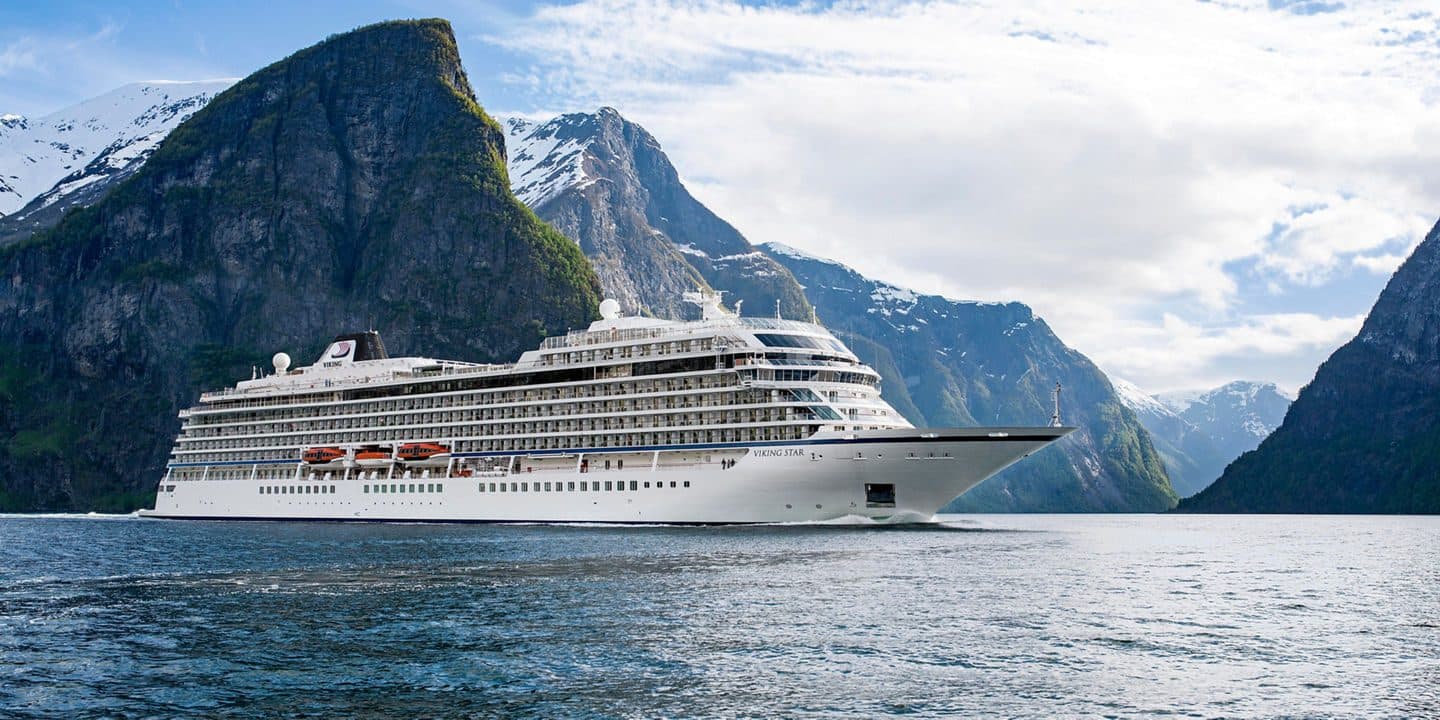 Luxury cruise ship in scenic fjord