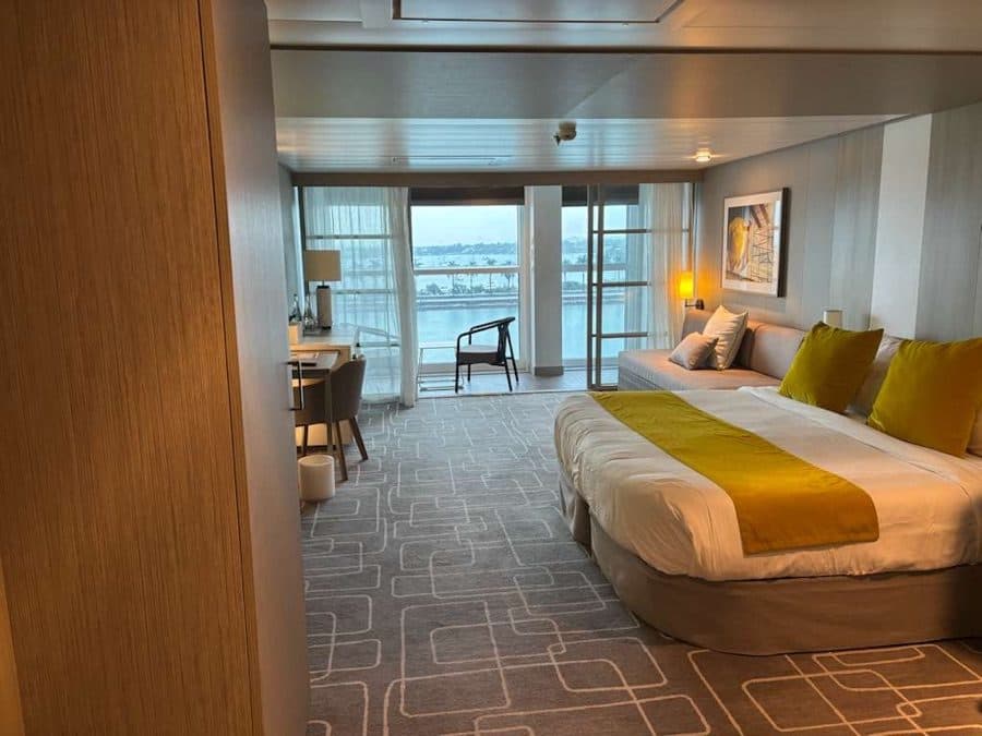 A suite bedroom with the balcony door open